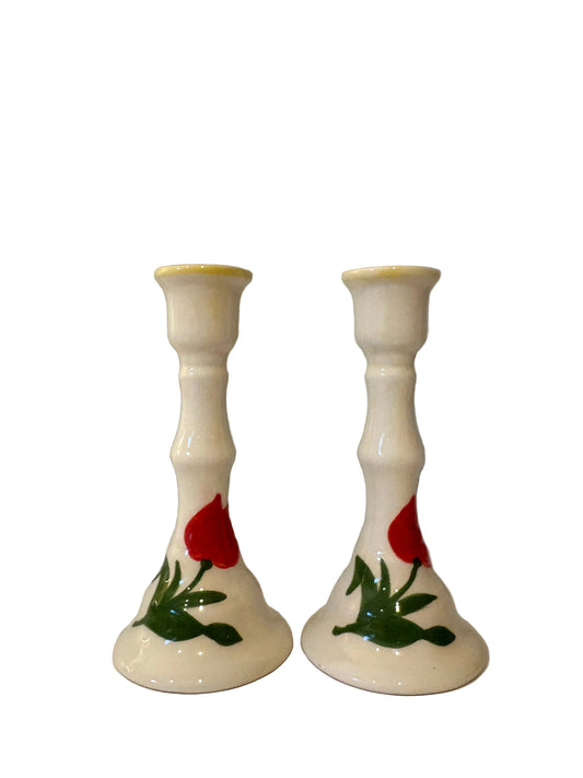 Matching tulip candlestick pair with red flowers, green leaves and yellow rim accents